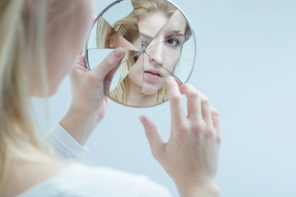 young-woman-touching-reflection-broken-787208227.jpg