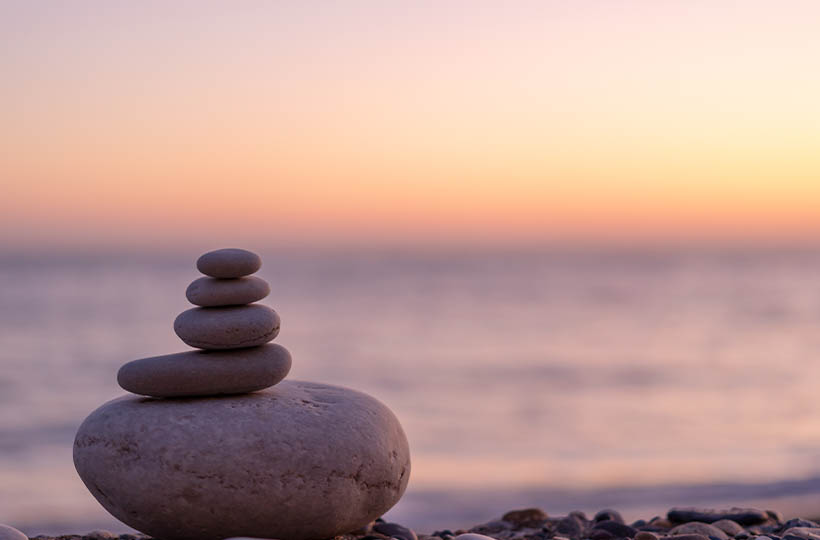 perfect-balance-stack-pebbles-seaside-towards-sunset.jpg